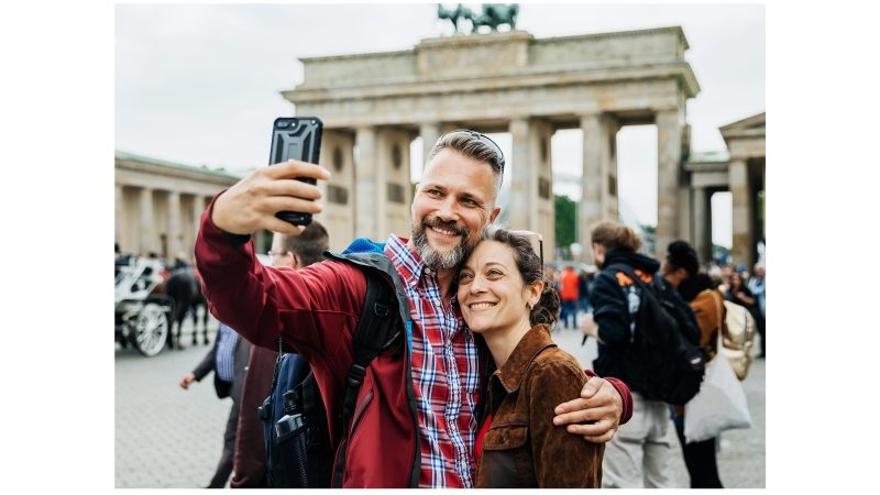 A Couple Takes A Selfie Together In Front Of Brandenburg Gate in Berlin